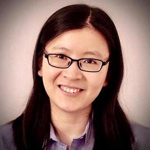 Fengxiu Zhang stands and smiles