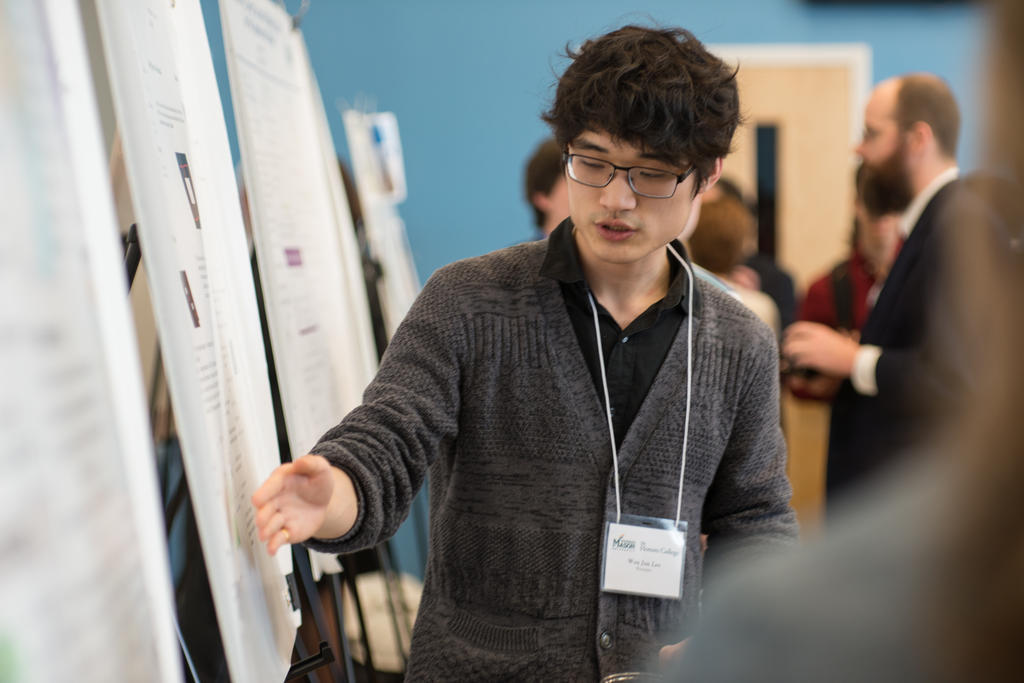 Student presenting his research board