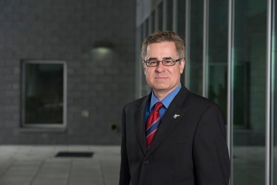 Dean Mark Rozell standing in front of Van Metre Hall